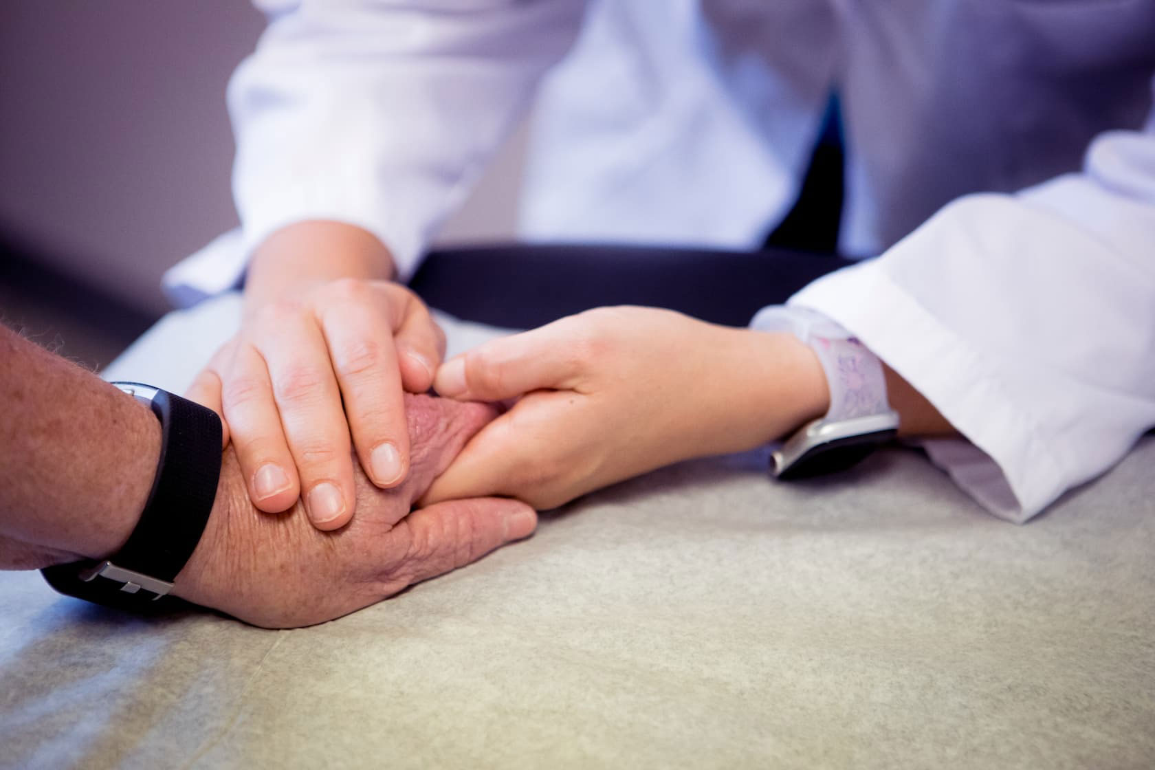 Doctor holding patient's hand