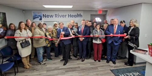 Cutting a ribbon of the new building opening